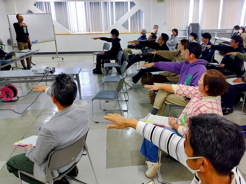 写真1　腕の上げ具合でグループづくりをする川野氏